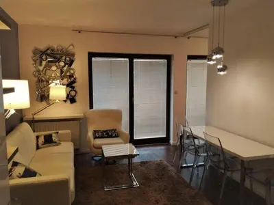 a living room with a couch and a table at Pawia Apartments Modern 2 in Kraków