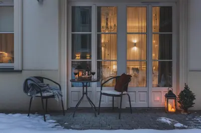 two chairs and a table in front of a building at Atrium - Old Town Luxury Apartments - by Upstairs in Kraków