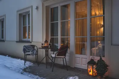 a patio with a table and chairs in front of a building at Atrium - Old Town Luxury Apartments - by Upstairs in Kraków