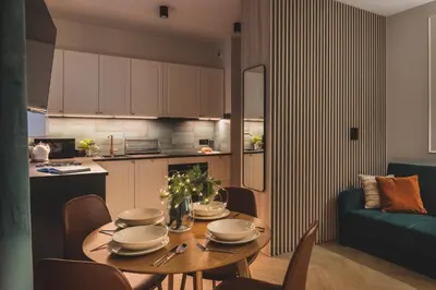 a kitchen and dining room with a table and chairs at Atrium - Old Town Luxury Apartments - by Upstairs in Kraków