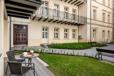 a patio with a table and chairs in front of a building at Atrium - Old Town Luxury Apartments - by Upstairs in Kraków