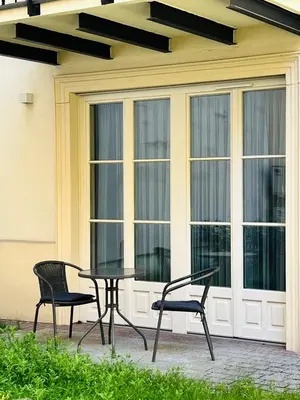 a table and two chairs sitting next to a window at Atrium - Old Town Luxury Apartments - by Upstairs in Kraków