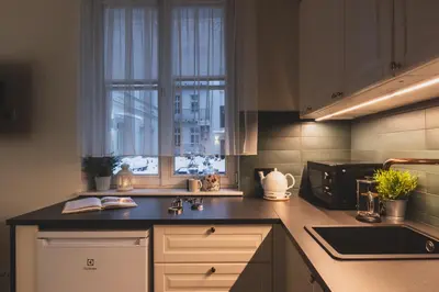 a kitchen with a sink and a microwave at Atrium - Old Town Luxury Apartments - by Upstairs in Kraków