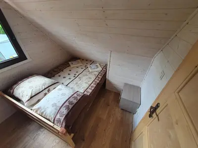 an overhead view of a bed in a tiny house at Domki Harnaś Energylandia in Przeciszów