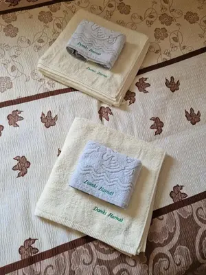 two towels sitting on top of a table at Domki Harnaś Energylandia in Przeciszów