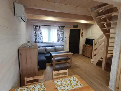 a living room with a couch and a table at Domki Harnaś Energylandia in Przeciszów