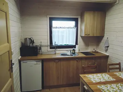 a small kitchen with a sink and a window at Domki Harnaś Energylandia in Przeciszów
