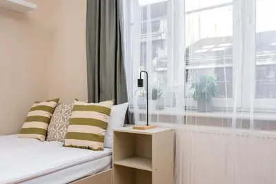 a small bedroom with a bed and a window at Spacious Apartment Around The Food Market - 5' to the Market Square - by Upstairs in Kraków