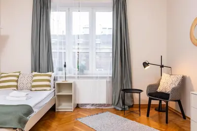 a living room with a bed and a window at Spacious Apartment Around The Food Market - 5' to the Market Square - by Upstairs in Kraków