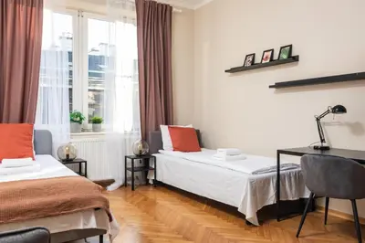 a bedroom with two beds and a desk and a window at Spacious Apartment Around The Food Market - 5' to the Market Square - by Upstairs in Kraków