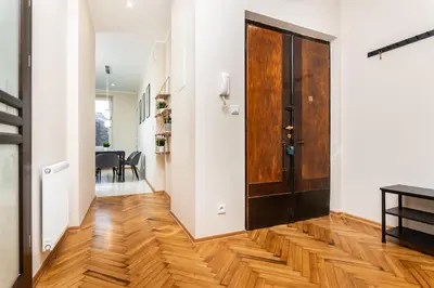 a hallway with a wooden door and a dining room at Spacious Apartment Around The Food Market - 5' to the Market Square - by Upstairs in Kraków