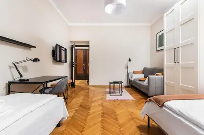 a bedroom with a desk and a couch at Spacious Apartment Around The Food Market - 5' to the Market Square - by Upstairs in Kraków