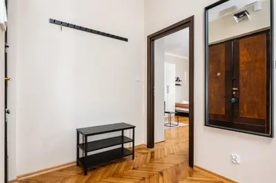 a hallway with a mirror and a table at Spacious Apartment Around The Food Market - 5' to the Market Square - by Upstairs in Kraków