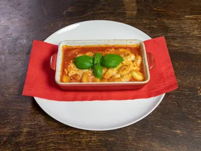 a bowl of food on a plate on a table at Suite Loft in Zabierzów