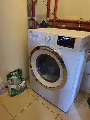a white washing machine sitting in a room at Suite Loft in Zabierzów
