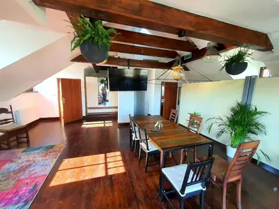 a dining room with a wooden table and chairs at Suite Loft in Zabierzów