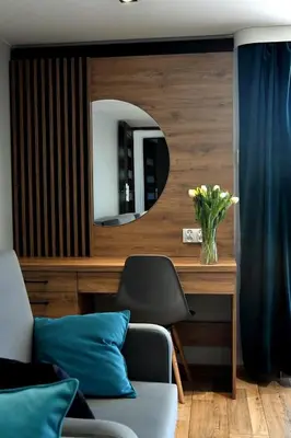 a living room with a chair and a mirror at Apartament Anna in Bachowice
