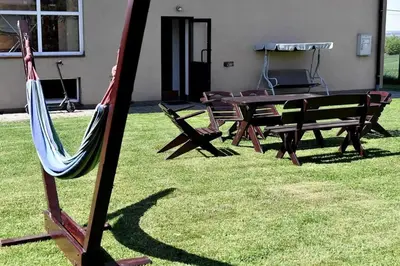 a hammock and a picnic table in a yard at Apartament Anna in Bachowice