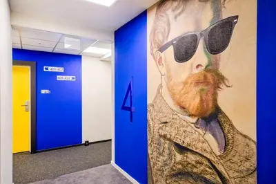 a painting of a man with a beard and sunglasses on a wall at Easy One Premium Art in Kraków