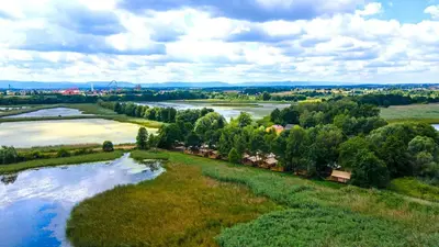an aerial view of a river and a field at Zatoria Luxury Glamping ZATOR in Zator