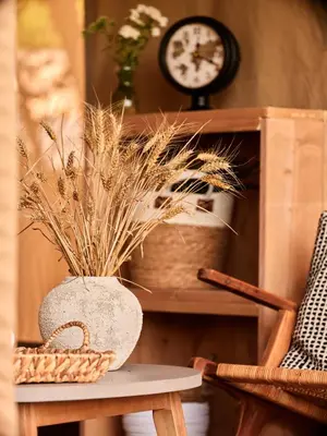 a table with a vase and a clock on a shelf at Zatoria Luxury Glamping ZATOR in Zator