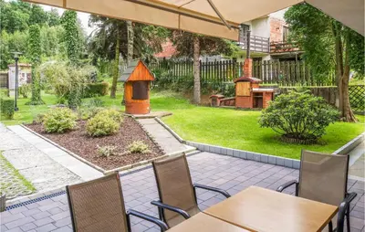 a patio with tables and a bird house in a yard at Ranczo in Mogilany