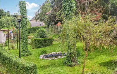 a garden with a tree and a street light at Ranczo in Mogilany