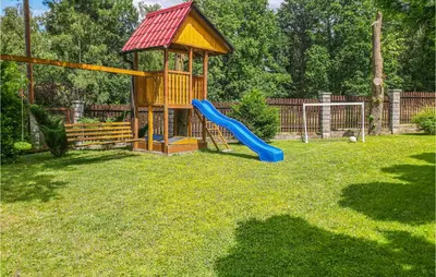 a playground with a blue slide and a gazebo at Ranczo in Mogilany