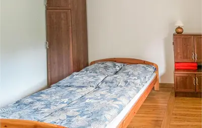 a bedroom with a bed and a dresser at Ranczo in Mogilany