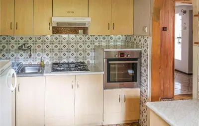 a kitchen with a sink and a stove top oven at Ranczo in Mogilany