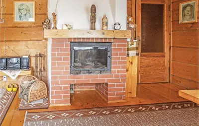 a brick fireplace in a room with a wooden floor at Gorgeous Home In Mucharz With Sauna in Mucharz