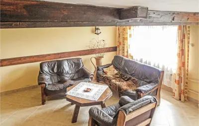 a living room with leather chairs and a table at Gorgeous Home In Mucharz With Sauna in Mucharz