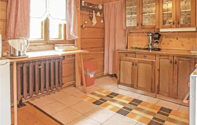a kitchen with wooden cabinets and a radiator at Gorgeous Home In Mucharz With Sauna in Mucharz
