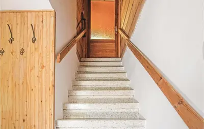 a staircase in a house with a wooden door at Gorgeous Home In Mucharz With Sauna in Mucharz
