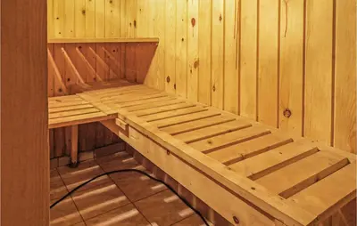 a wooden sauna with a wooden bench in it at Gorgeous Home In Mucharz With Sauna in Mucharz
