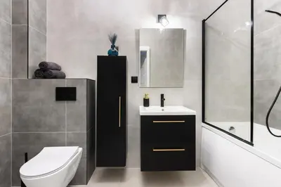 a bathroom with a toilet a sink and a mirror at Margaret Apartment in Kraków
