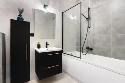 a bathroom with a sink and a tub and a shower at Margaret Apartment in Kraków
