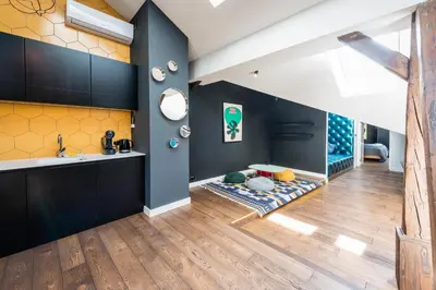 a living room with a sink and a table at Wegierska Luxury Loft WAWELOFTS in Kraków