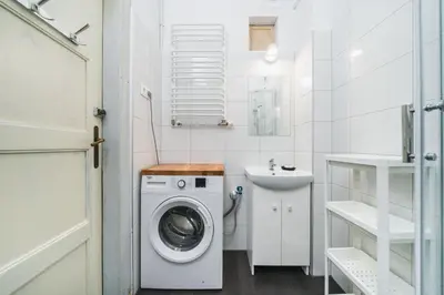 a white bathroom with a washing machine and a sink at Apartments in The Jewish Quarter - LOW STANDARD - 10' Main Square - by Upstairs in Kraków