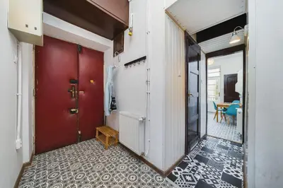 a hallway with a red door and a table at Apartments in The Jewish Quarter - LOW STANDARD - 10' Main Square - by Upstairs in Kraków