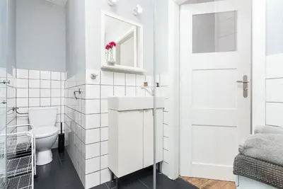 a white bathroom with a toilet and a sink at Apartments in The Jewish Quarter - LOW STANDARD - 10' Main Square - by Upstairs in Kraków