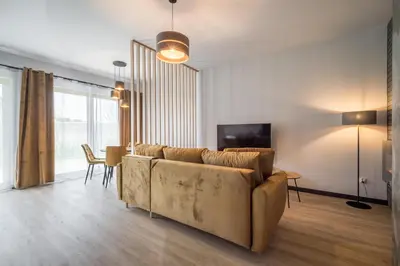 a living room with a couch and a table at Rakowicka Old Town Luxury Apartments WAWELOFTS in Kraków