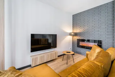 a living room with a couch and a fireplace at Rakowicka Old Town Luxury Apartments WAWELOFTS in Kraków