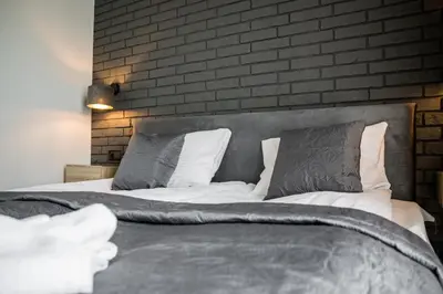 a living room with a bed and a couch in a room at Rakowicka Old Town Luxury Apartments WAWELOFTS in Kraków