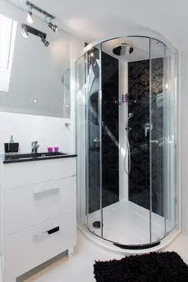 a glass shower in a bathroom with a sink at Neo Apartments in Kraków