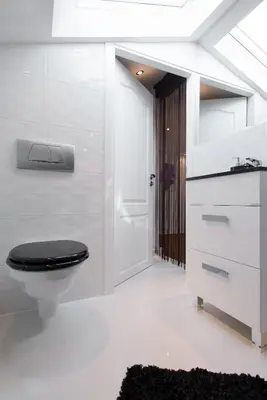 a bathroom with a toilet with a black seat at Neo Apartments in Kraków