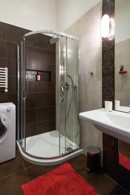 a bathroom with a shower and a sink at Neo Apartments in Kraków