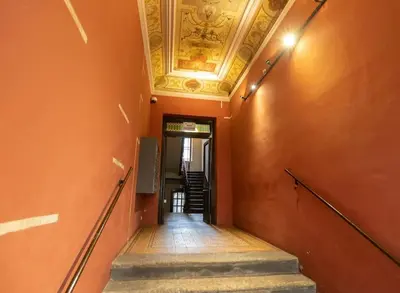 a hallway with a ceiling and stairs in a building at Salve station in Kraków