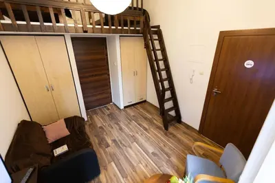 a room with a loft bed and a staircase at Salve station in Kraków