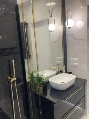 a bathroom with a white sink and a mirror at Apartamenty Parkowe B18 in Oświęcim